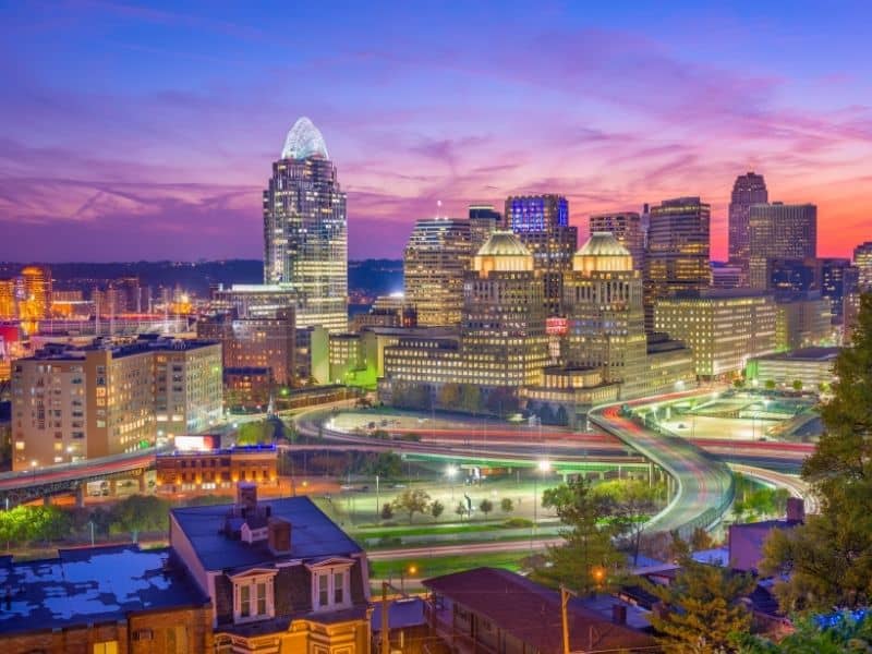 Downtown Cincinnati, Ohio skyline at sunset with commercial buildings, transportation corridors, and urban development areas relevant to land surveying projects