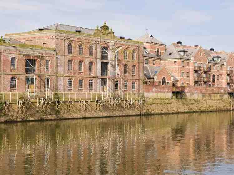 Riverfront buildings near the water showing why elevation certificate review matters for flood risk and insurance