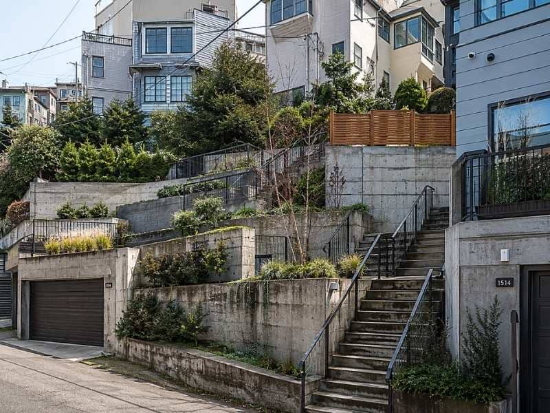 Stepped urban property with retaining walls, stairways and abrupt elevation changes requiring detailed topographic mapping.
